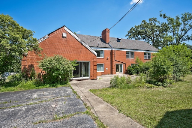20020 Western Ave, Olympia Fields, IL 60461 - back of house featuring brick siding, a yard, and a chimney