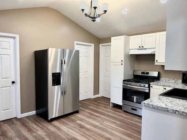 108 E 5th St, Spring Valley, IL 61362 - kitchen featuring stainless steel appliances, under cabinet range hood, vaulted ceiling, light wood-type flooring, and white cabinetry