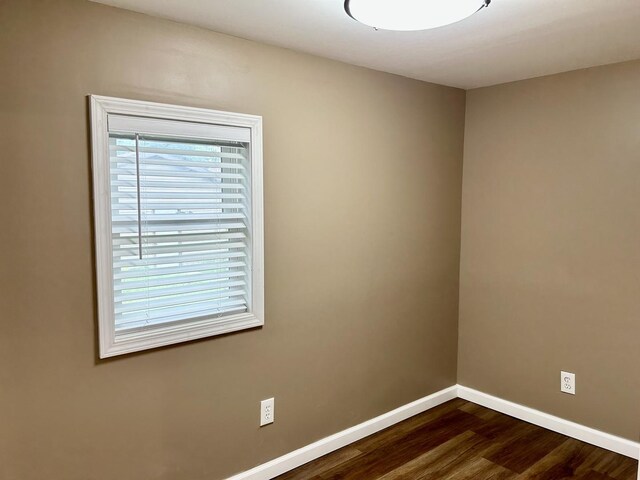 108 E 5th St, Spring Valley, IL 61362 - empty room featuring dark wood finished floors and baseboards