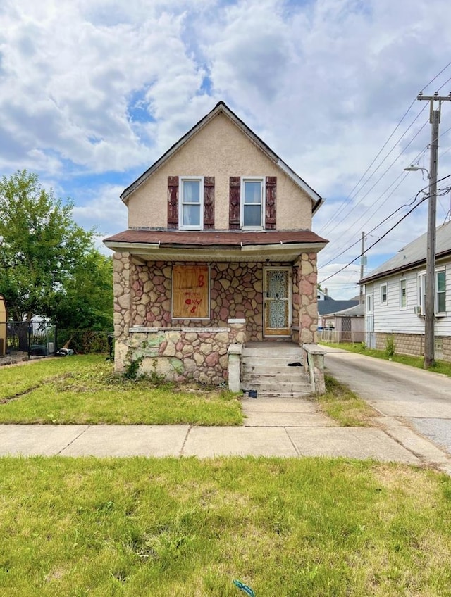 8636 S Union Ave, Chicago, IL 60620 - view of front facade featuring stone siding, covered porch, a front lawn, and stucco siding