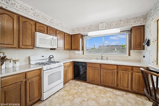 1583 Bayview Dr, Lake Zurich, IL 60047 - kitchen with white appliances, wallpapered walls, brown cabinets, and light countertops