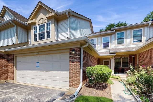 2328 Sedgfield Ct, Schaumburg, IL 60194 - multi unit property featuring brick siding, an attached garage, and asphalt driveway