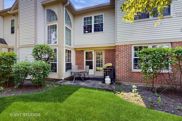 2328 Sedgfield Ct, Schaumburg, IL 60194 - rear view of house featuring a patio, brick siding, and a yard