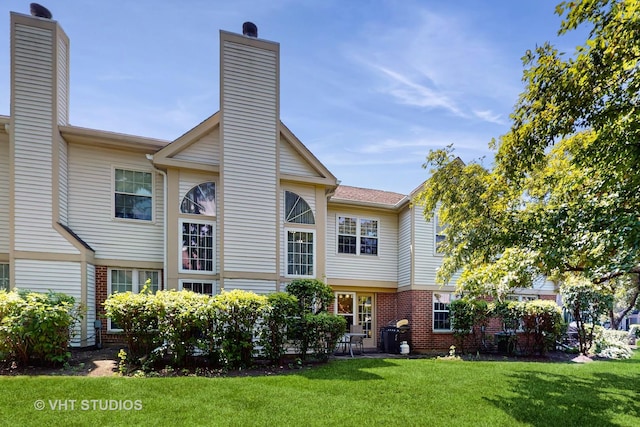 2328 Sedgfield Ct, Schaumburg, IL 60194 - back of house with brick siding, a lawn, and a chimney