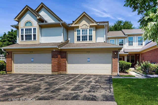 2328 Sedgfield Ct, Schaumburg, IL 60194 - view of front of property with a garage, asphalt driveway, brick siding, and a shingled roof