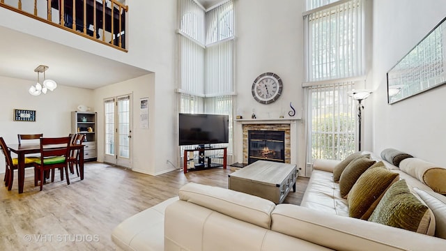 2328 Sedgfield Ct, Schaumburg, IL 60194 - living area featuring a towering ceiling, wood finished floors, a chandelier, and a fireplace