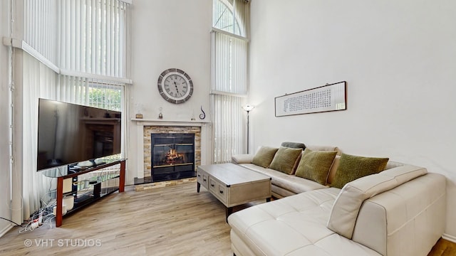 2328 Sedgfield Ct, Schaumburg, IL 60194 - living room featuring a high ceiling, a fireplace, and wood finished floors