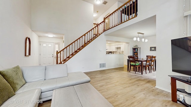 2328 Sedgfield Ct, Schaumburg, IL 60194 - living area featuring a high ceiling, wood finished floors, stairway, and a chandelier