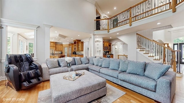 761 Reserve Ct, South Elgin, IL 60177 - living room featuring ornate columns, stairway, a high ceiling, light wood-style floors, and recessed lighting