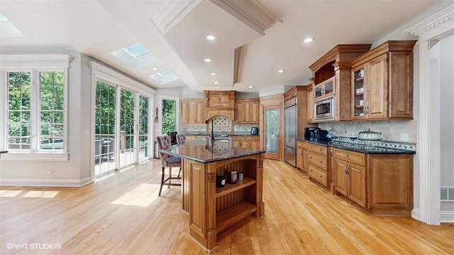 761 Reserve Ct, South Elgin, IL 60177 - kitchen featuring built in appliances, open shelves, a skylight, light wood-type flooring, and recessed lighting