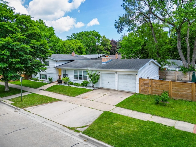 1339 Fowler Ave, Evanston, IL 60201 - view of front of property featuring a garage, concrete driveway, a chimney, and roof with shingles