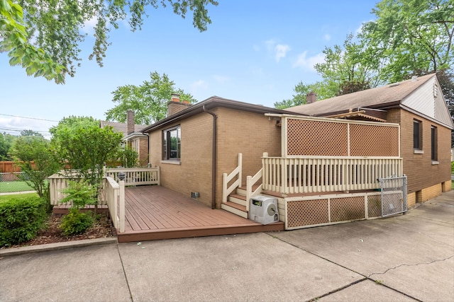 3941 Wesley Ave, Stickney, IL 60402 - view of front of property with a chimney, brick siding, a deck, a patio, and crawl space
