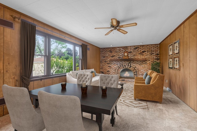 3941 Wesley Ave, Stickney, IL 60402 - carpeted dining area featuring wood walls, a brick fireplace, and a ceiling fan