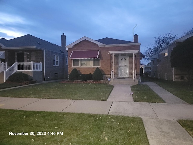 8230 S Albany Ave, Chicago, IL 60652 - bungalow featuring a chimney, a front yard, and brick siding