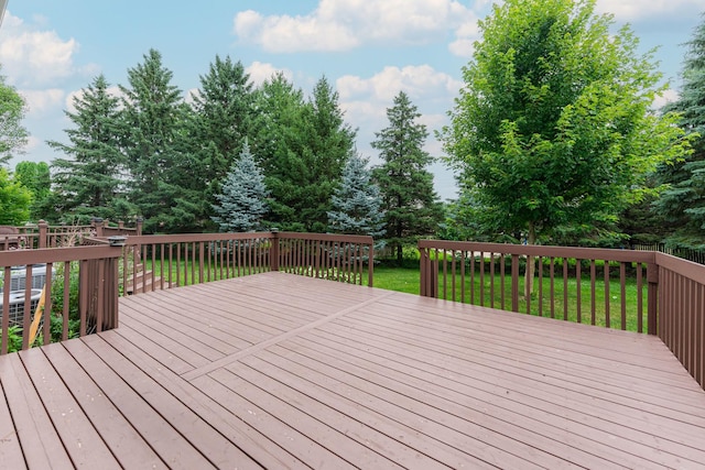 4 Meadow Trl W, Dekalb, IL 60115 - deck featuring a lawn and view of wooded area