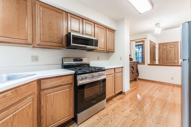 4 Meadow Trl W, Dekalb, IL 60115 - kitchen with appliances with stainless steel finishes, light wood finished floors, and light countertops