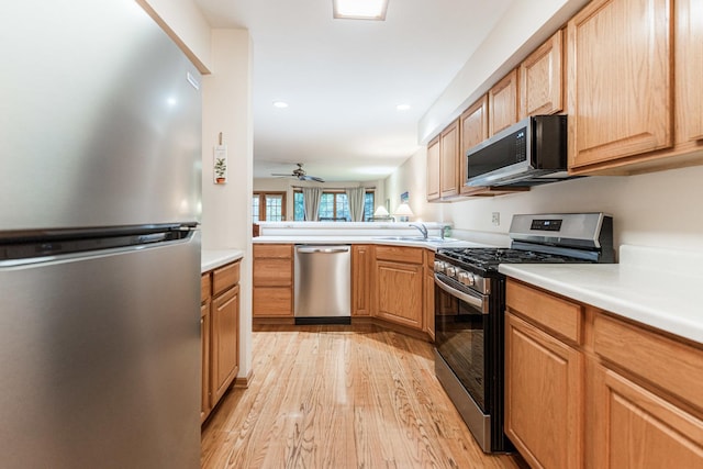 4 Meadow Trl W, Dekalb, IL 60115 - kitchen featuring stainless steel appliances, light wood-type flooring, light countertops, ceiling fan, and recessed lighting