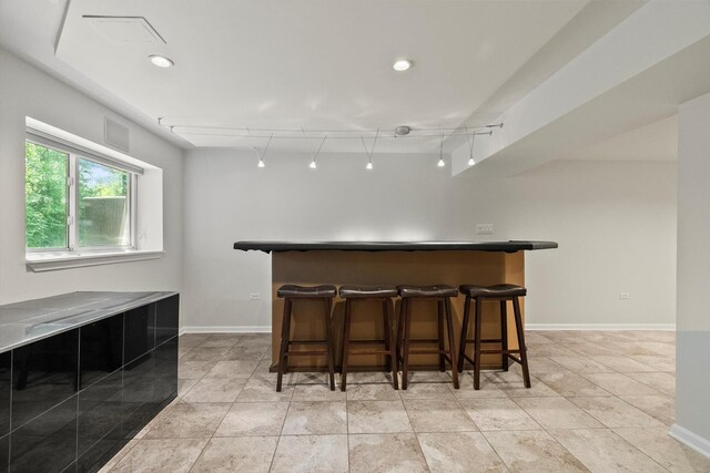 377 Aaron Ln, Bolingbrook, IL 60440 - indoor dry bar featuring rail lighting and baseboards