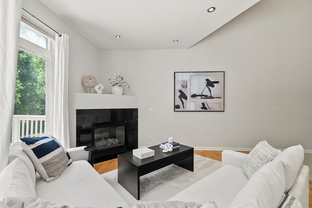 377 Aaron Ln, Bolingbrook, IL 60440 - living area with light wood-type flooring, a tiled fireplace, and recessed lighting