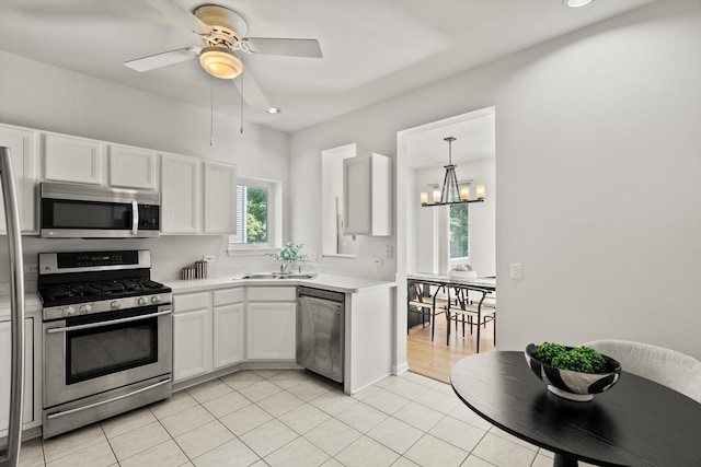 377 Aaron Ln, Bolingbrook, IL 60440 - kitchen featuring appliances with stainless steel finishes, light countertops, a chandelier, white cabinets, and recessed lighting
