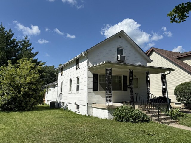 310 E Chippewa St, Dwight, IL 60420 - view of front of house with a front yard, covered porch, and cooling unit