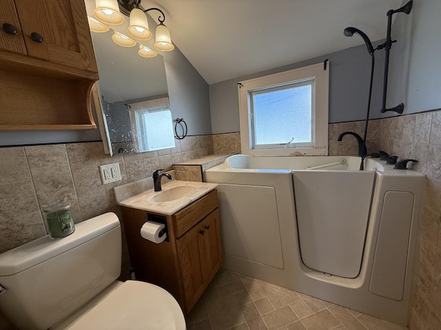 310 E Chippewa St, Dwight, IL 60420 - full bath with tile walls, tile patterned flooring, vanity, a bath, and washer and clothes dryer