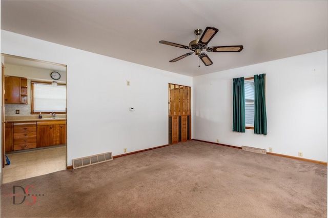 132 New St, Seneca, IL 61360 - spare room featuring a ceiling fan and light carpet