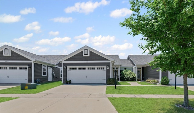 3013 E Stillwater Lndg Unit 3013, Urbana, IL 61802 - view of front of home featuring driveway, a front lawn, and a garage