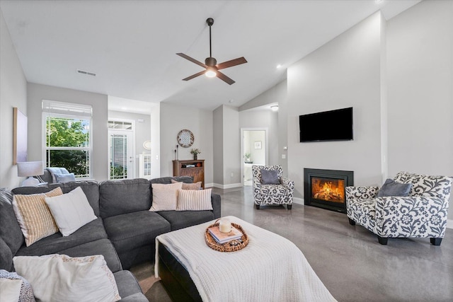 3013 E Stillwater Lndg Unit 3013, Urbana, IL 61802 - living area featuring concrete floors, a lit fireplace, a ceiling fan, recessed lighting, and high vaulted ceiling