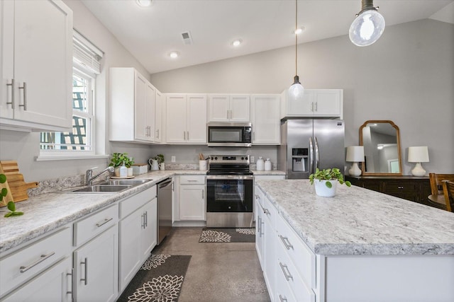 3013 E Stillwater Lndg Unit 3013, Urbana, IL 61802 - kitchen featuring stainless steel appliances, lofted ceiling, white cabinetry, a center island, and finished concrete floors