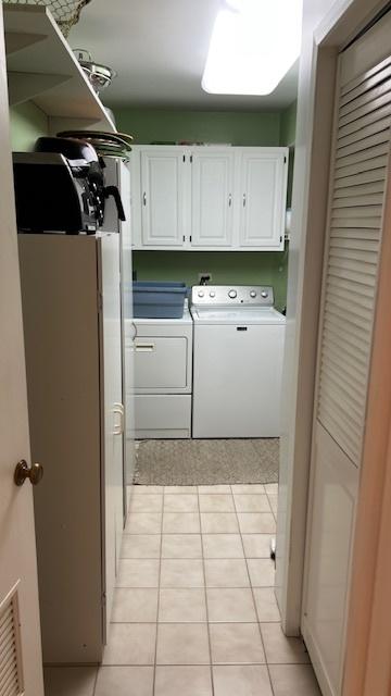 13216 N Country Club Ct Unit 2Aa, Palos Heights, IL 60463 - laundry area featuring cabinet space, washing machine and clothes dryer, and light tile patterned floors