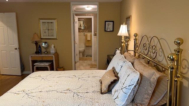 13216 N Country Club Ct Unit 2Aa, Palos Heights, IL 60463 - bedroom featuring connected bathroom and wood finished floors