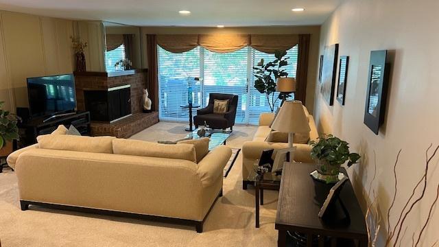 13216 N Country Club Ct Unit 2Aa, Palos Heights, IL 60463 - living room featuring healthy amount of natural light, a brick fireplace, carpet floors, and recessed lighting