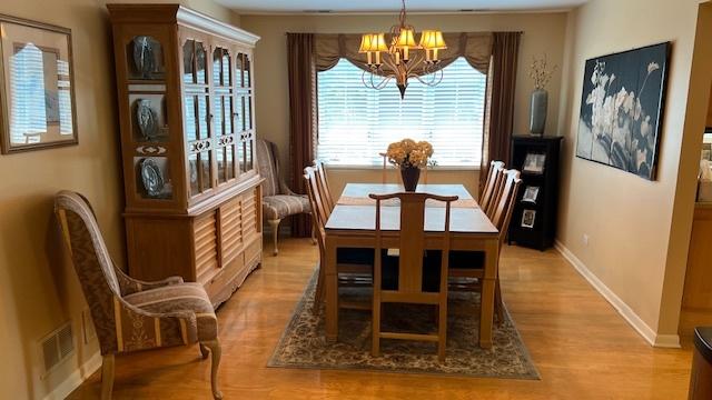 13216 N Country Club Ct Unit 2Aa, Palos Heights, IL 60463 - dining space with a chandelier and light wood-style floors