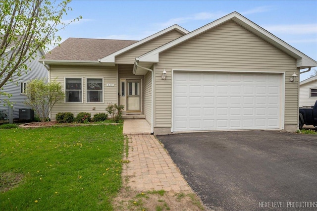 317 Plymouth Ct, Sycamore, IL 60178 - single story home featuring a garage, a front lawn, driveway, and roof with shingles