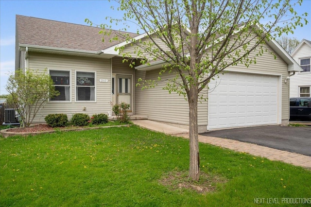 317 Plymouth Ct, Sycamore, IL 60178 - ranch-style home featuring asphalt driveway, a garage, a front lawn, and roof with shingles