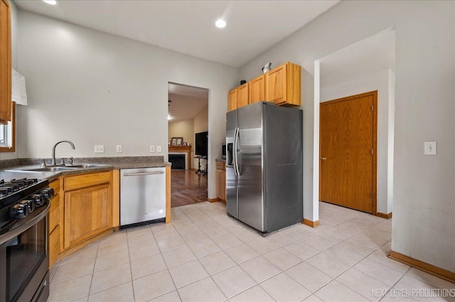 317 Plymouth Ct, Sycamore, IL 60178 - kitchen with appliances with stainless steel finishes, dark countertops, light tile patterned floors, and recessed lighting