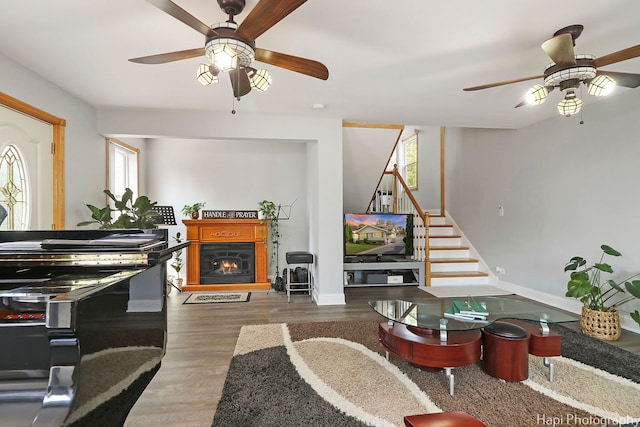1569 Sherman Pl, Des Plaines, IL 60016 - living area featuring ceiling fan, stairs, a lit fireplace, and wood finished floors