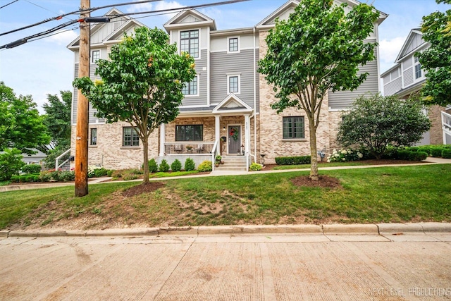 520 Ohio Ave, Saint Charles, IL 60174 - townhome / multi-family property with a porch, a front lawn, and brick siding