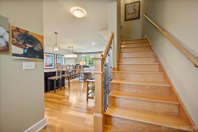 520 Ohio Ave, Saint Charles, IL 60174 - stairway featuring wood finished floors and a chandelier