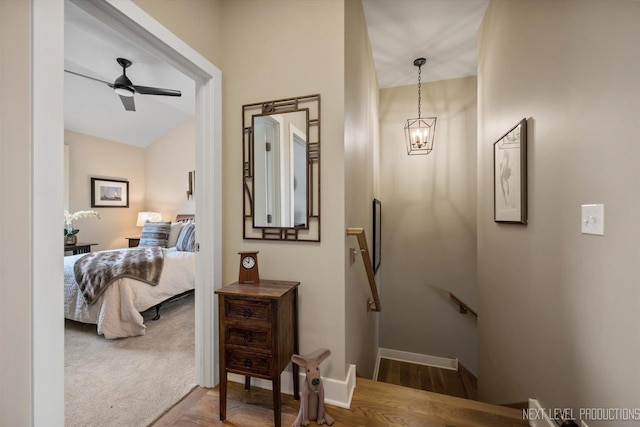 520 Ohio Ave, Saint Charles, IL 60174 - corridor featuring an upstairs landing, a chandelier, and wood finished floors
