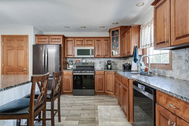 1245 Patriot Way, Bourbonnais, IL 60914 - kitchen with appliances with stainless steel finishes, brown cabinetry, stone counters, decorative backsplash, and recessed lighting
