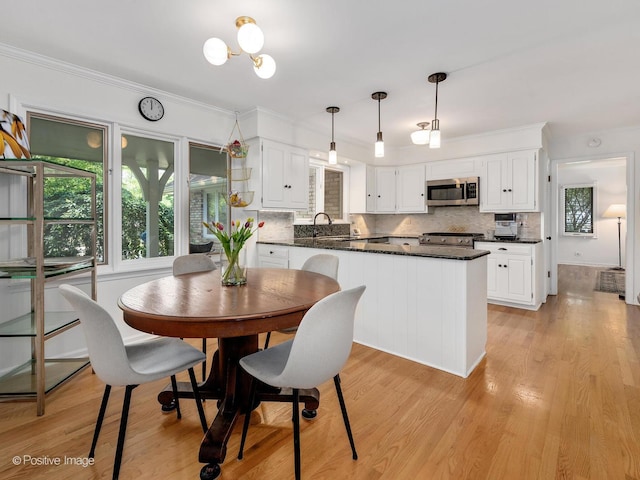 262 Sheffield Ln, Glen Ellyn, IL 60137 - kitchen with stainless steel microwave, backsplash, white cabinetry, pendant lighting, and ornamental molding