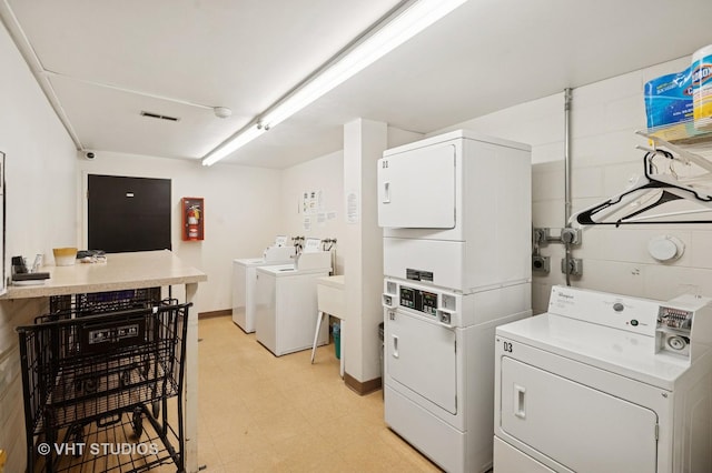 9331 Landings Ln Unit 204, Des Plaines, IL 60016 - community laundry room with stacked washer and clothes dryer, washer and clothes dryer, and light flooring