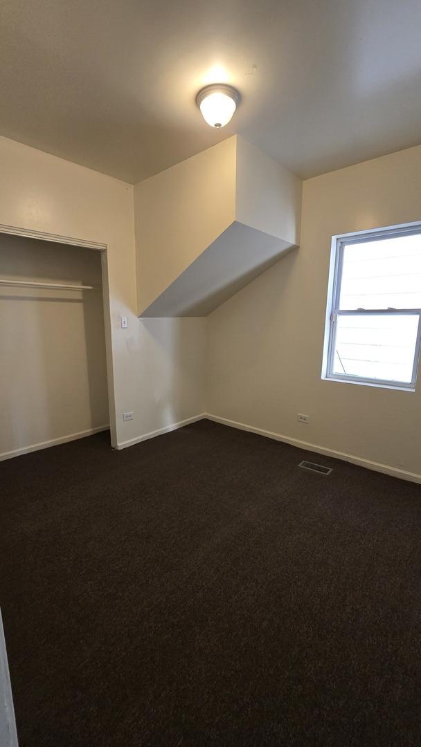 1233 Otto Blvd, Chicago Heights, IL 60411 - bonus room featuring baseboards and dark colored carpet