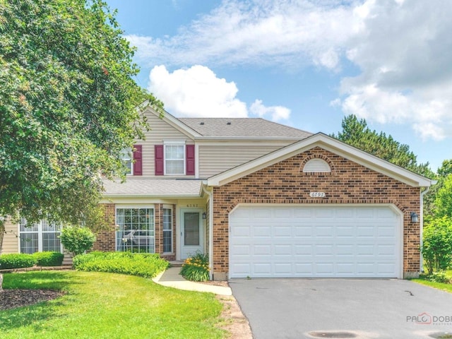 6797 Roanoake Ct, Gurnee, IL 60031 - traditional home with brick siding, asphalt driveway, a front lawn, and an attached garage