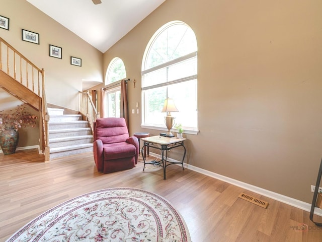 6797 Roanoake Ct, Gurnee, IL 60031 - living area with stairs, wood finished floors, high vaulted ceiling, and ceiling fan