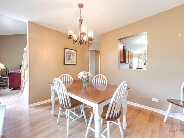 6797 Roanoake Ct, Gurnee, IL 60031 - dining area with a chandelier and light wood-type flooring