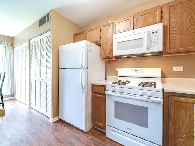 6797 Roanoake Ct, Gurnee, IL 60031 - kitchen featuring white appliances, dark wood-type flooring, light countertops, and brown cabinets