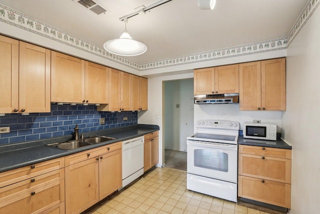 1495 S County Farm Rd Unit 2-4, Wheaton, IL 60189 - kitchen with white appliances, under cabinet range hood, dark countertops, decorative backsplash, and rail lighting